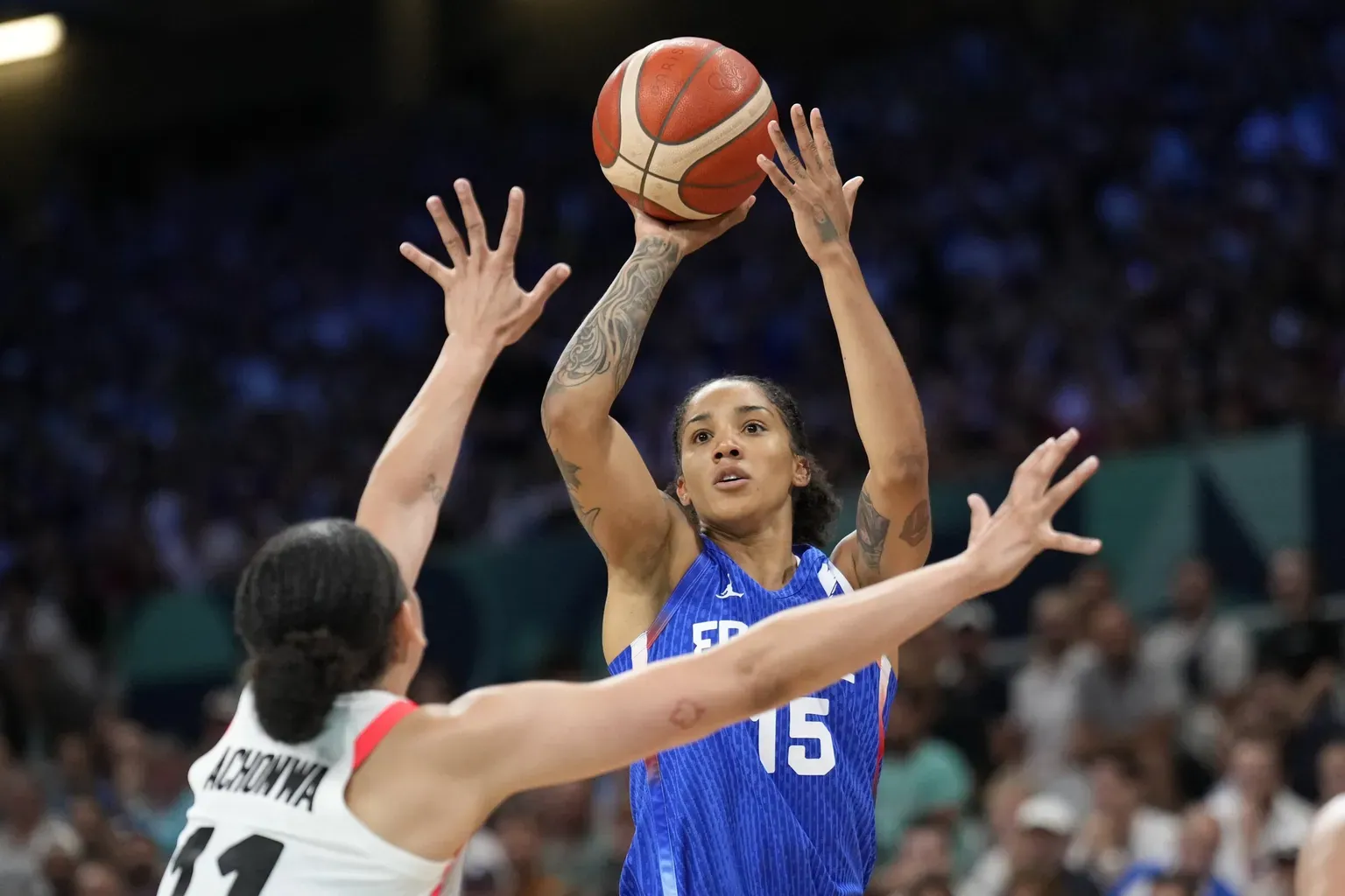 Gabby Williams of France shoots over Natalie Achonwa of Canada at the 2024 Summer Olympics.