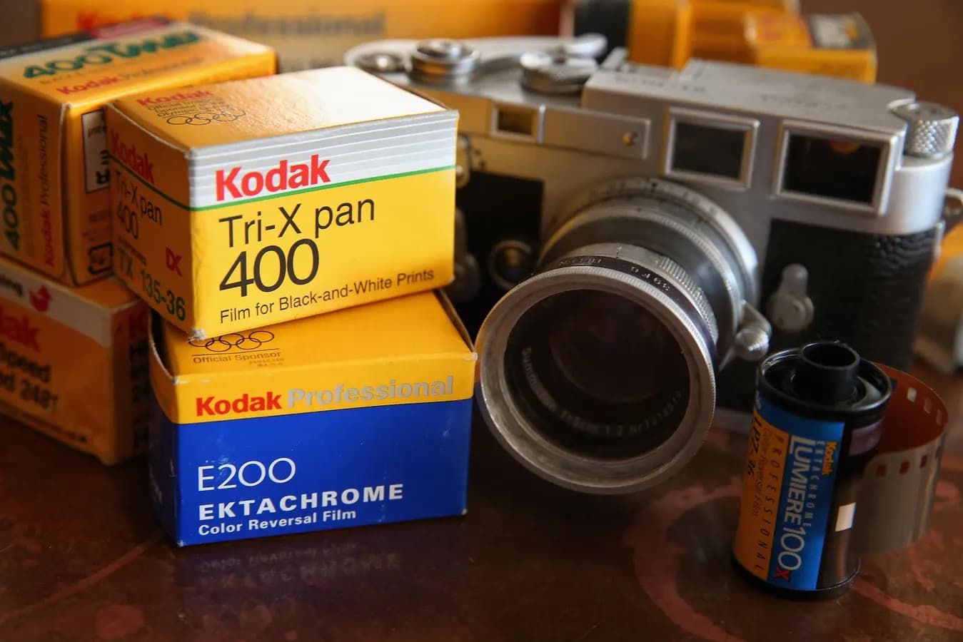 Two boxes of Kodak Gold 200 35mm film beside a rangefinder camera.