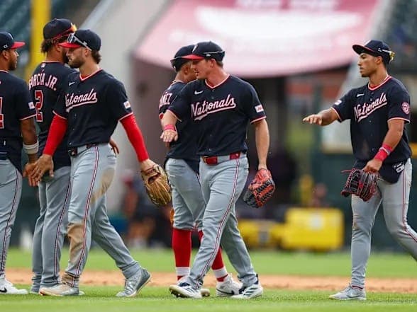 Washington Nationals players celebrate on the field after a win.