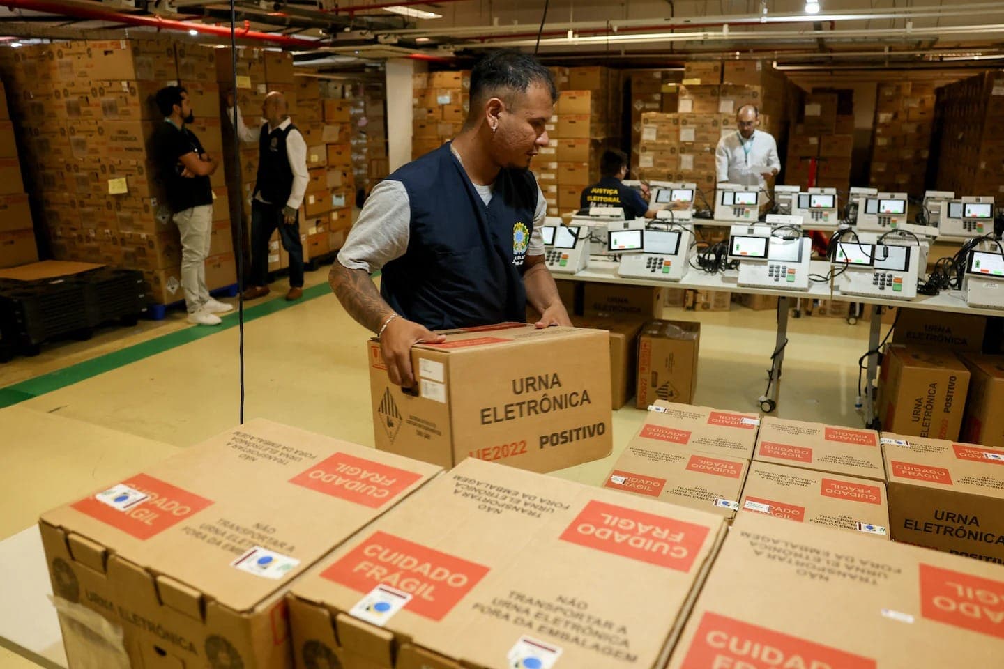 A worker stacks boxes containing Brazilian electronic voting machines during testing preparations in Manaus.