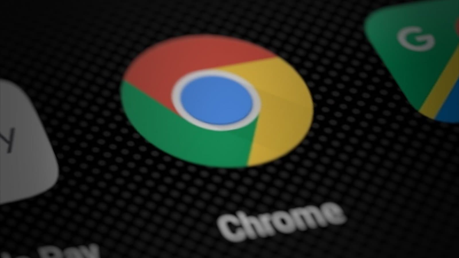 Close-up of the red, yellow, green and blue Google Chrome app icon with the word Chrome beneath it on a dark smartphone home screen.