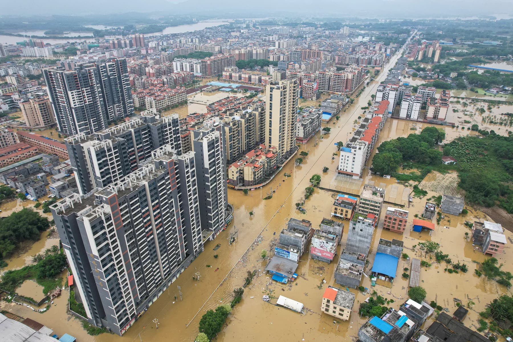 Aerial view of floodwater running between apartment towers through a city in southern China.