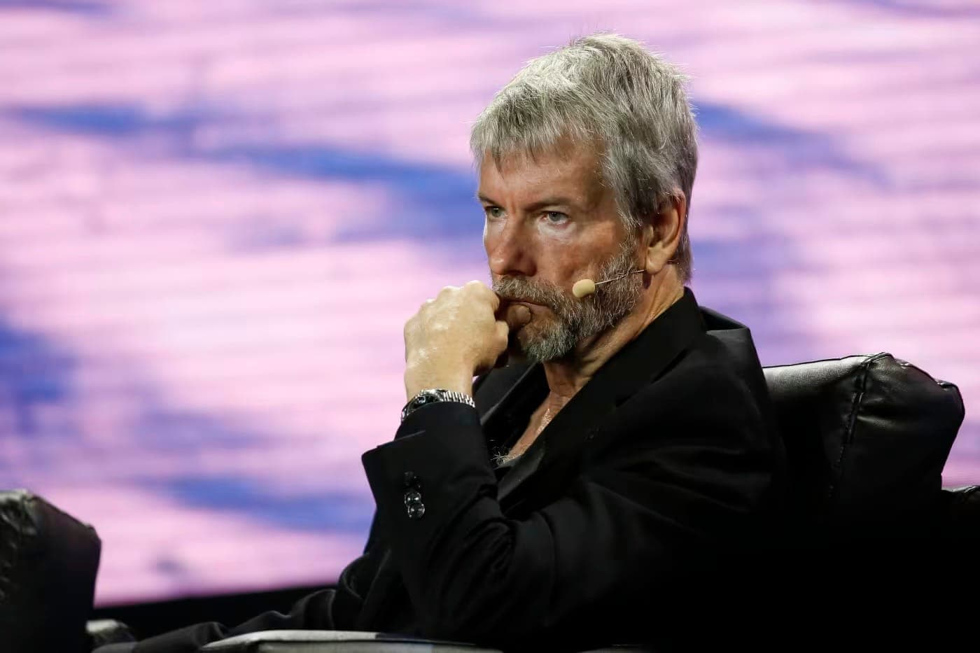Michael Saylor seated on stage with his hand raised to his chin.