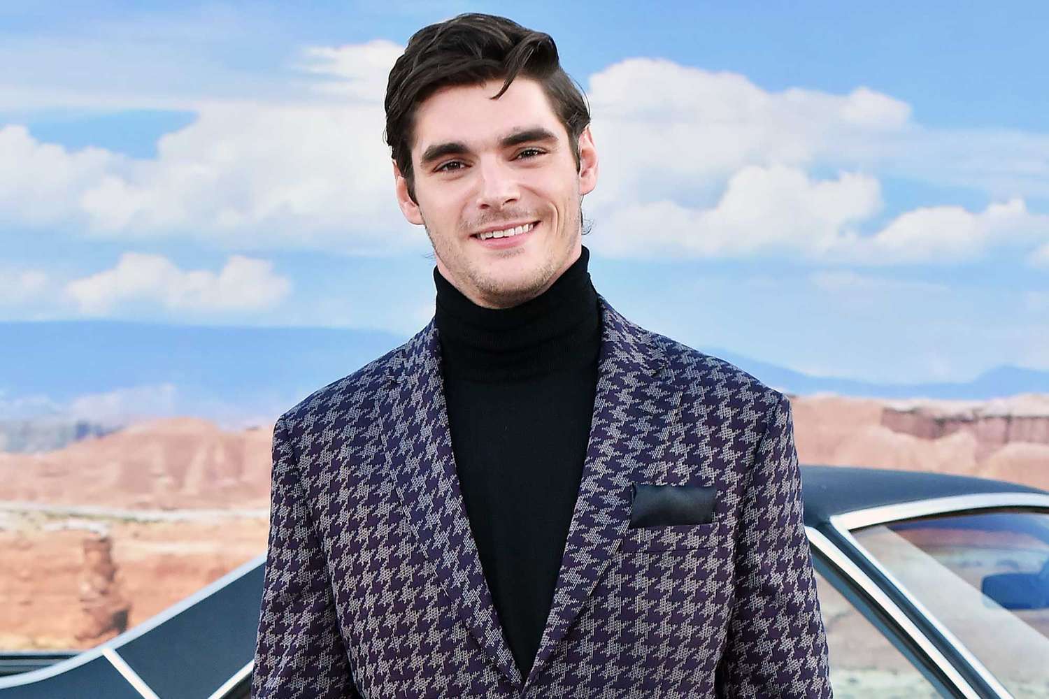 RJ Mitte photographed outdoors in a patterned turtleneck.