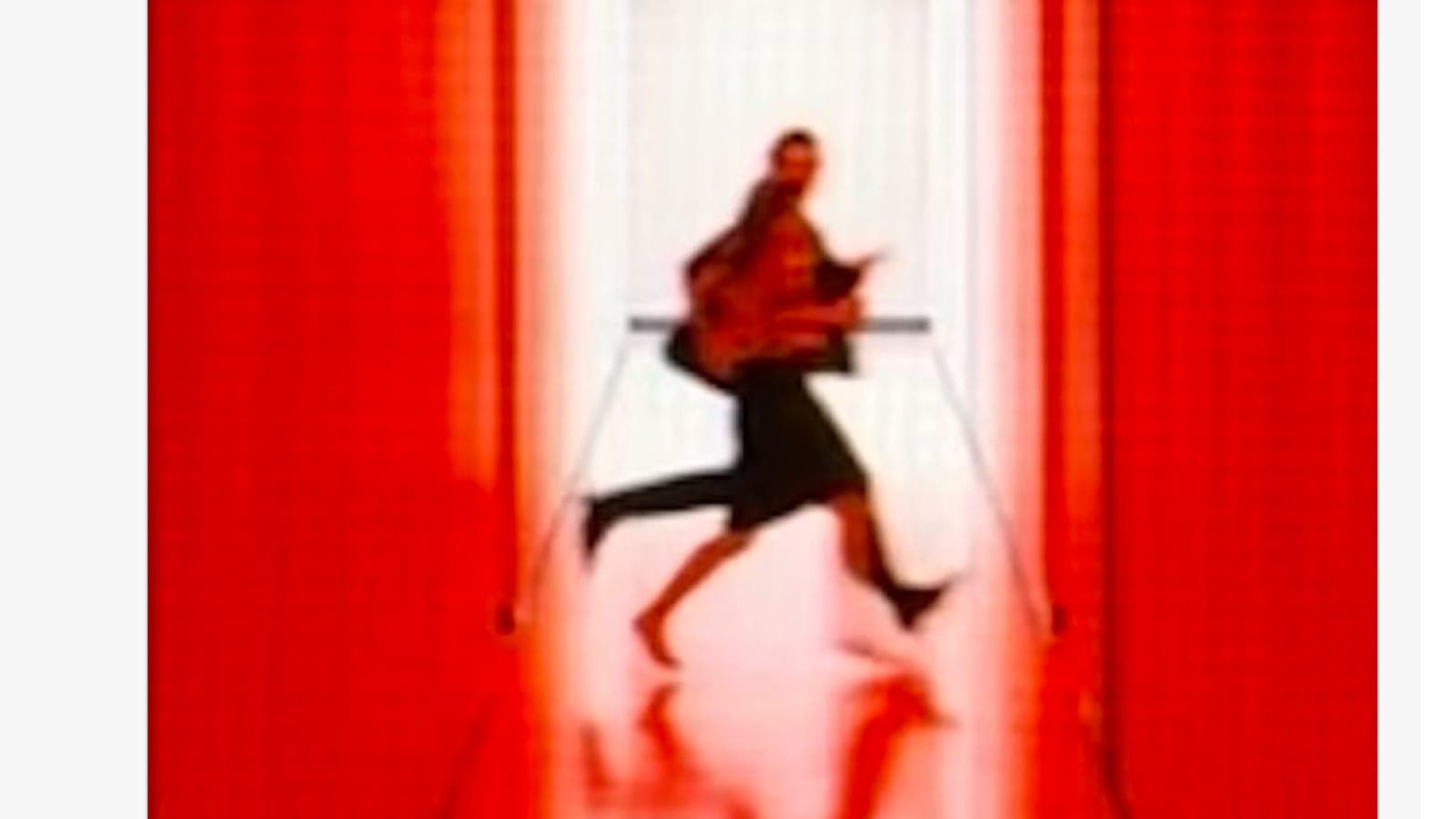 Ben Stiller's post on X quoting Kier Eagan, with a blurry image of two figures running down a red Lumon corridor.