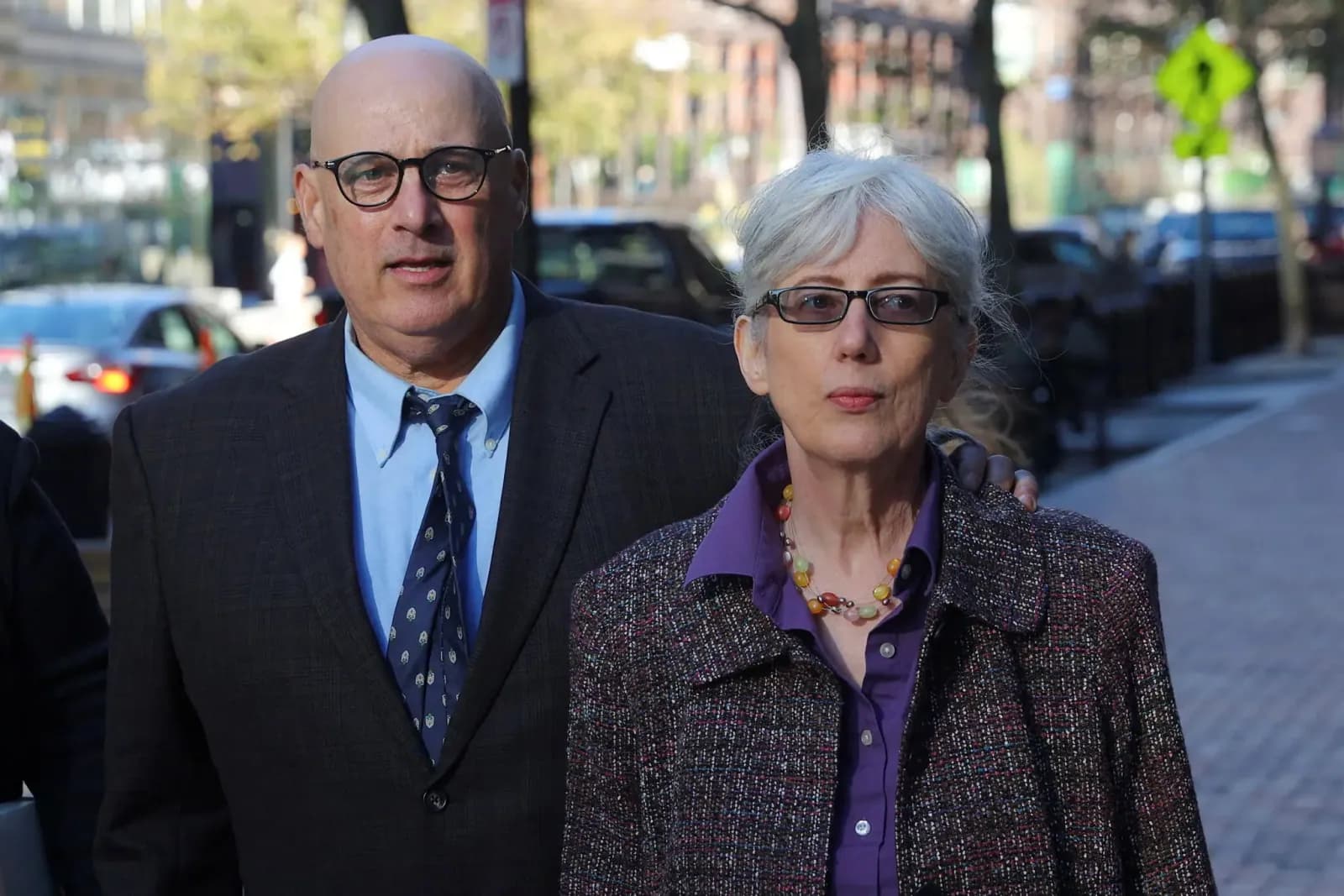 David and Ina Steiner walking outside a courthouse in Boston.