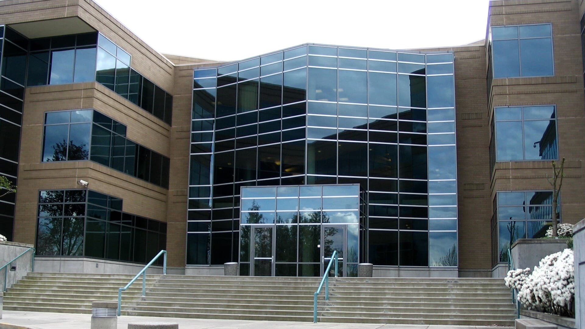 Glass-fronted entrance and wide concrete steps of Building 17 at Microsoft's headquarters campus in Redmond, Washington.