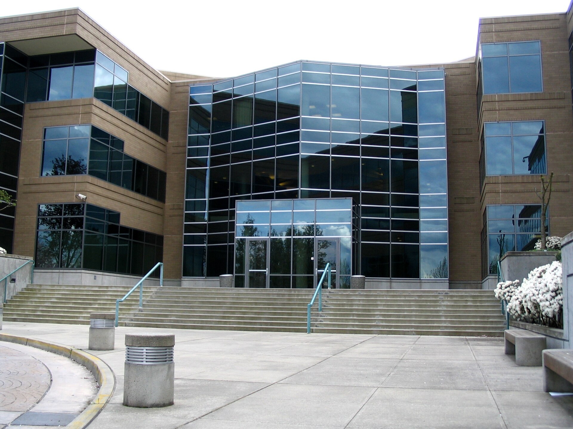 Glass-fronted entrance and wide concrete steps of Building 17 at Microsoft's headquarters campus in Redmond, Washington.