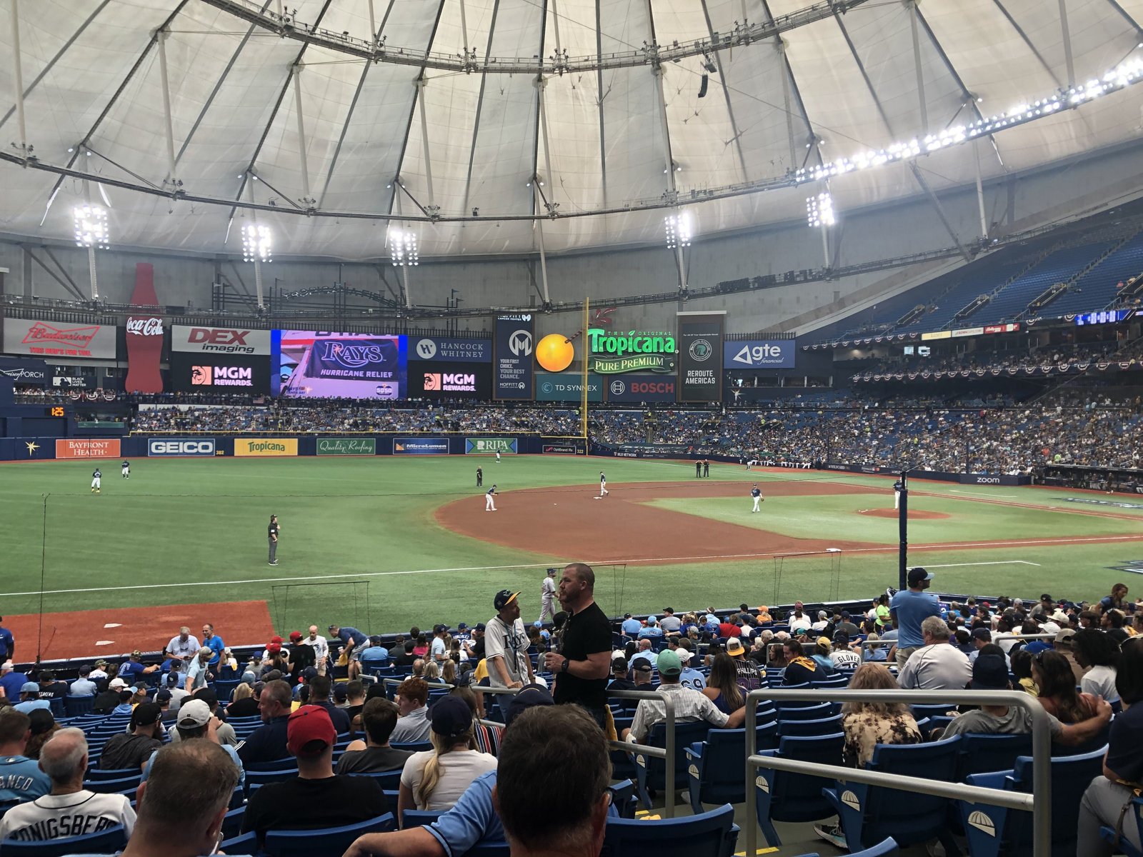 View from the stands at Tropicana Field's domed ballpark during a playoff game, with fans in the lower bowl and the infield below.